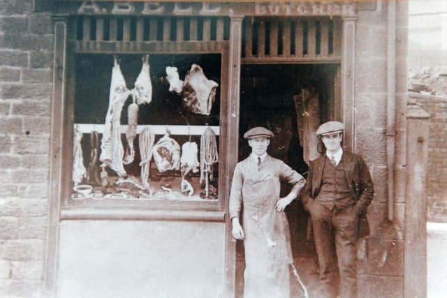 Maurice Bell (left) and a member of staff standing outside the family butchers.