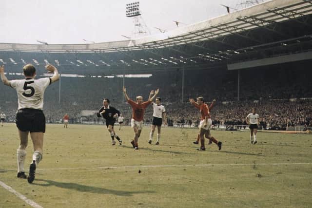 Bobby Charlton (centre) holds his hands up as West German players protest after Geoff Hurst scores the controversial third goal during the World Cup final at Wembley Stadium on July 30, 1966. Picture: Cattani/Fox Photos/Getty Images.