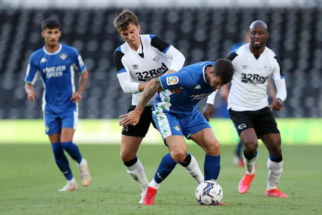 Aitor Ruibal of Real Betis battles for possession with Tom Carroll of Derby County during the Pre-Season Friendly match between Derby County and Real Betis at Pride Park on July 28, 2021 in Derby, England. (Photo by Charlotte Tattersall/Getty Images)