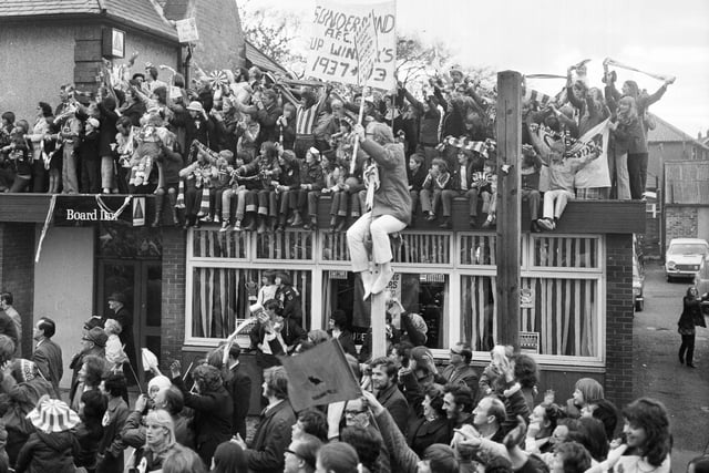 These fans packed on to the roof of the Board Inn, East Herrington, and even on to lampposts to get a view.