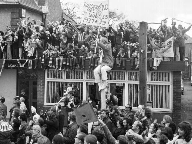These fans packed on to the roof of the Board Inn, East Herrington, and even on to lampposts to get a view.