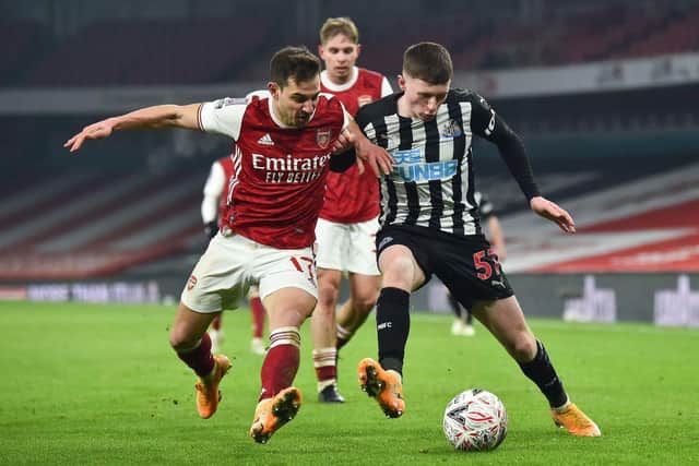 Arsenal's German-born Portuguese defender Cedric Soares (L) vies with Newcastle United's English midfielder Elliot Anderson (R) during the English FA Cup third round football match between Arsenal and Newcastle United at the Emirates Stadium in London on January 9, 2021  (Photo by GLYN KIRK/AFP via Getty Images)