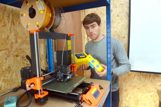 Chris Nutman at one of the 3D printers used to make the plastic casing for the projectors.