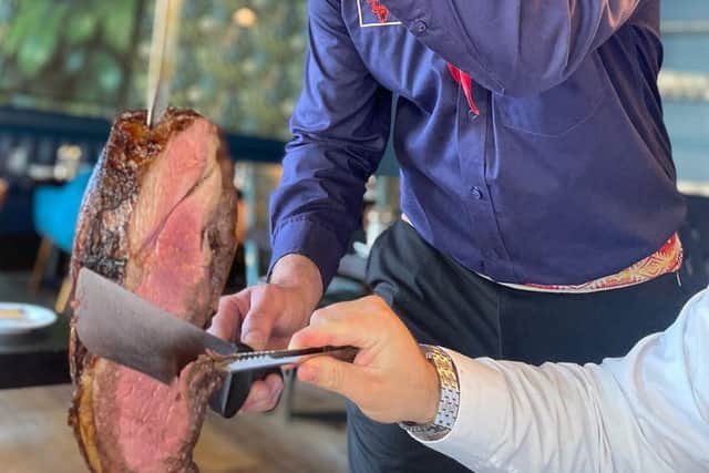 Gaucho chefs slice the meat at your table