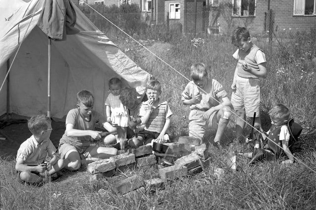 These young Wearsiders enjoy an early lunch of new potatoes at their camp near South Hylton in 1954.