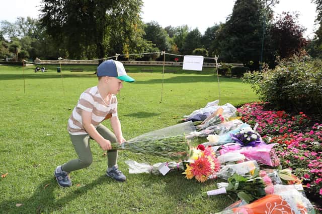 Dated: 11/09/2022
Four year old Jude Harrison leaves a floral tribute alongside dozens of bouquets of flowers at Mowbray Park in Sunderland, in memory of Queen Elizabeth II following her death last week.