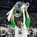 Thibaut Courtois celebrates with the trophy after the UEFA Champions League final football match between Liverpool and Real Madrid at the Stade de France in Saint-Denis, north of Paris, on May 28, 2022. - Real Madrid won the match 0-1. (Photo by JAVIER SORIANO / AFP) (Photo by JAVIER SORIANO/AFP via Getty Images)