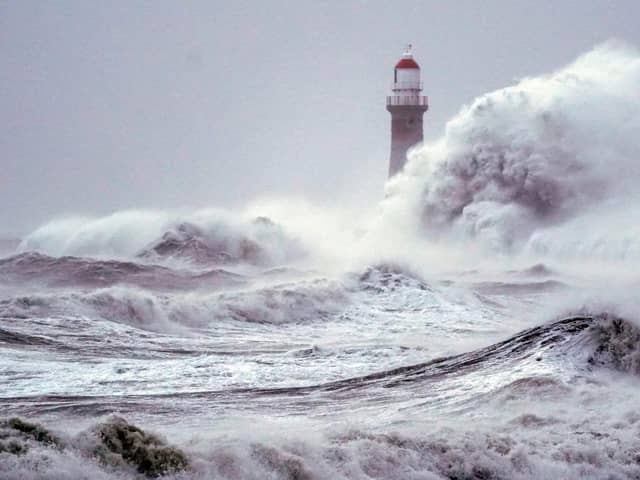Huge waves crash the against the sea wall and Roker Lighthouse in Sunderland during Storm Arwen which saw gusts of almost 100 miles per hour battering areas of the UK. Picture date: Saturday November 27, 2021.