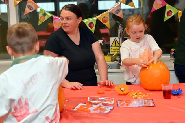 Children of Armed Forces veterans taking part in Halloween pumpkin carving at the Beacon of Light.