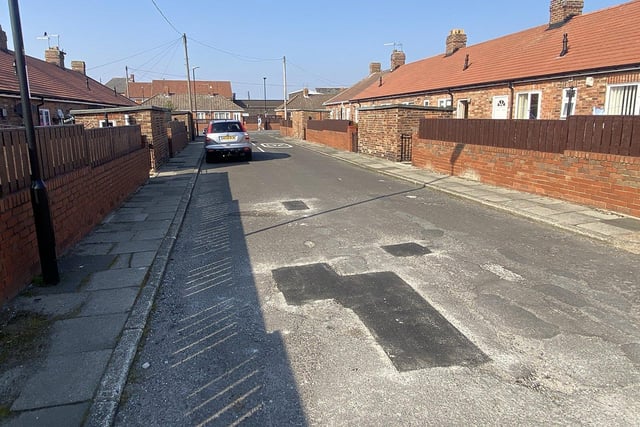 Evidence of potholes and some previous repair work on Emmerson Terrace.

Picture by FRANK REID.