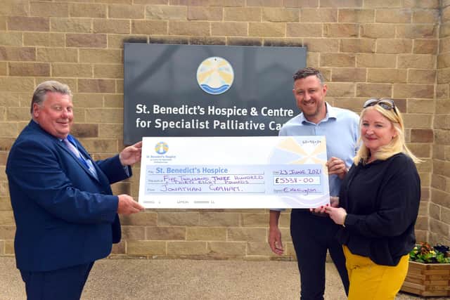 Ultra marathon runner Jonny Graham and Mark's widow Nicola Foster-Hird presents raised funds to St Benedict's Hospice chairman Derek Moss in memory of Mark Hird.