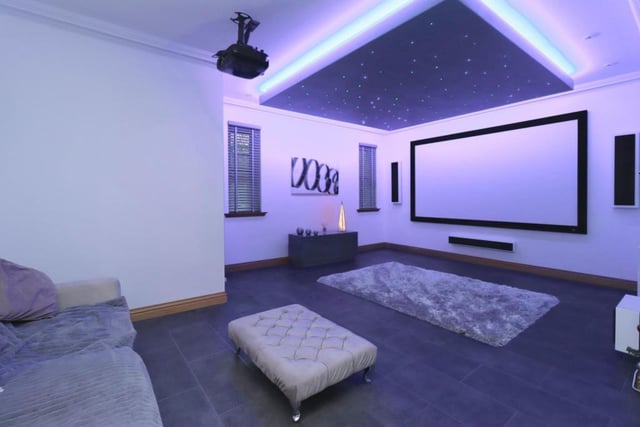 Cinema room fitted with surround sound, LED lights, cinema screen and star ceiling lights.