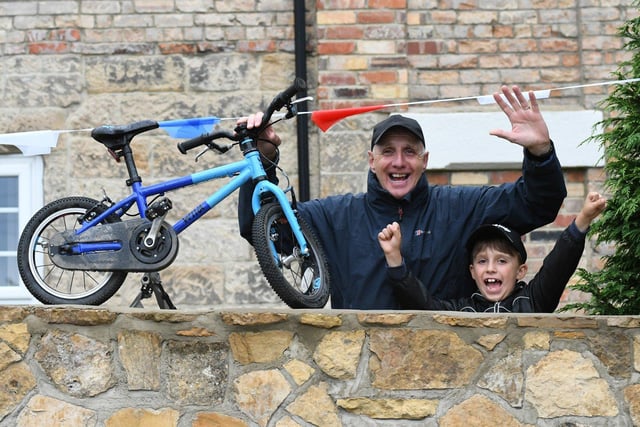 Newbottle residents Jiohn and son Henry, 7 prepare to cheer on the Tour of Britain cyclists as they pass through the village.