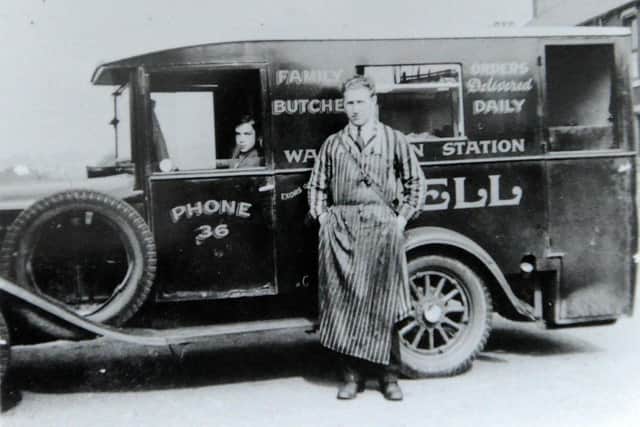 The grandfather of Alyson Chapman sitting in one of the company vans.