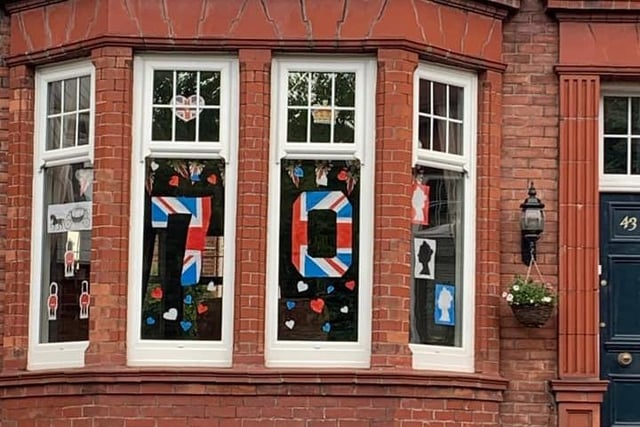 A very festive red, white and blue window display, complete with flags.