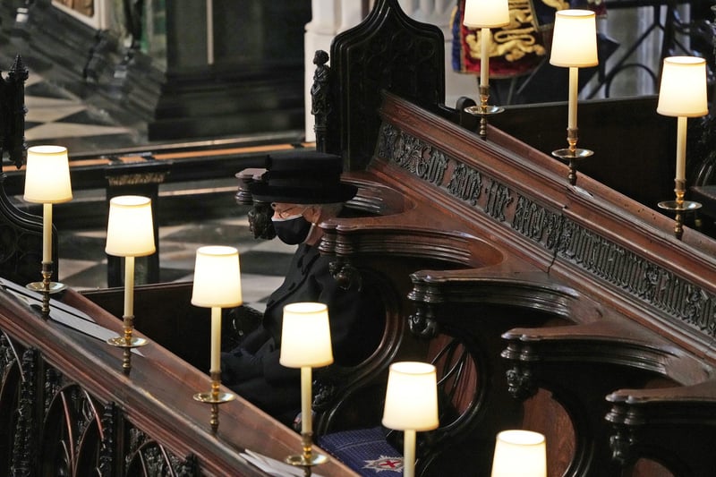 The Queen cut a lonely, mournful figure as she wiped away tears in St George’s Chapel during the Duke of Edinburgh’s funeral on Saturday.