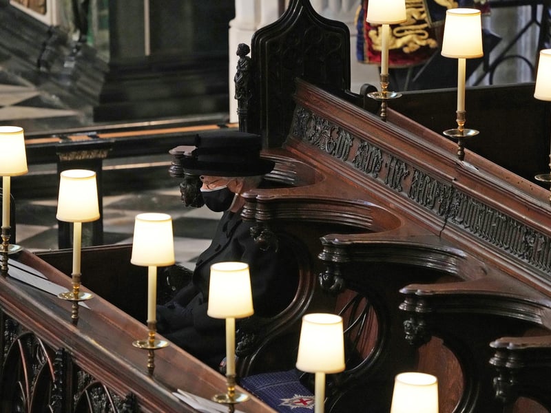The Queen cut a lonely, mournful figure as she wiped away tears in St George’s Chapel during the Duke of Edinburgh’s funeral on Saturday.