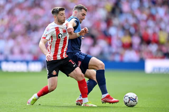 LONDON, ENGLAND - MAY 21: Lynden Gooch of Sunderland battles for possession with Sam Vokes of Wycombe Wanderers during the Sky Bet League One Play-Off Final match between Sunderland and Wycombe Wanderers at Wembley Stadium on May 21, 2022 in London, England. (Photo by Justin Setterfield/Getty Images)