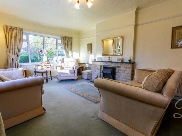 As we step inside the bungalow, here is the living room with its feature fireplace. It is a bright and airy space in which to relax.