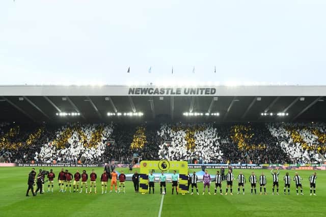 The teams line up against the backdrop of a Wor Flags display.