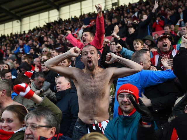 Sunderland fans celebrate their draw after the Premier League match between Stoke City and Sunderland at the Britannia Stadium on April 30, 2016.