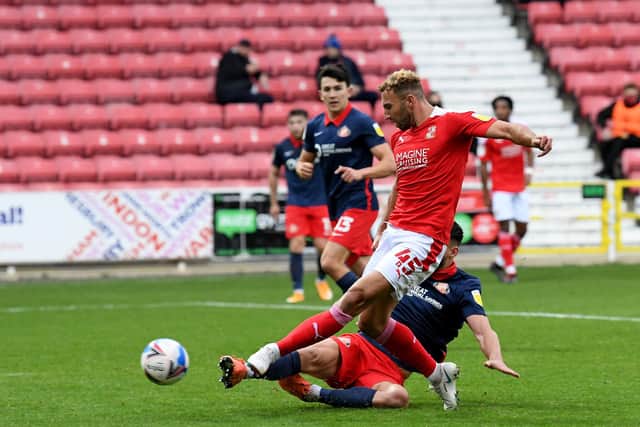 Bailey Wright makes a challenge at Swindon's County Ground