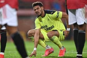Joelinton in pain at Old Trafford.