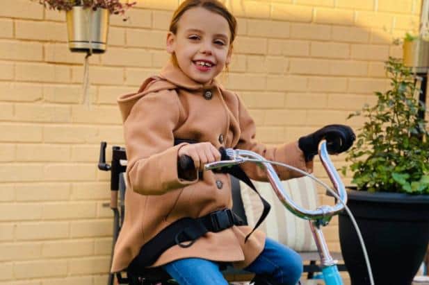 Chanel Murrish on her new trike, bought with thanks to the Red Sky Foundation.