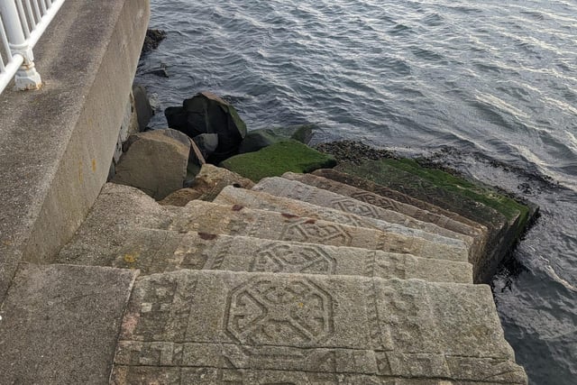 Walk round to Roker Marina, and the Stone Stair Carpet is easy to miss as it descends into the water - but it's worth finding. The steps, made from reclaimed sandstone, were carved by Colin Wilbourn to represent a patterned stair carpet which gradually changes as it nears the seawater into images of seaweed and chains.
