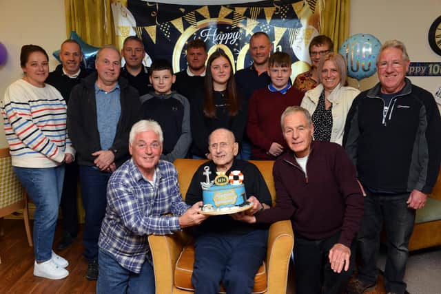 George Bell celebrates his 100th birthday with his family, friends and two son's John and George (Right).