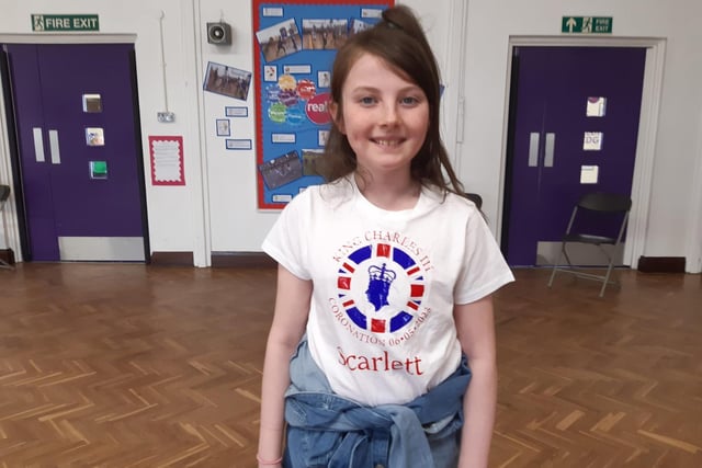 Hasting Hill Academy pupil Scarlett Rigby, nine, with the special edition t-shirt she had made for the Coronation.