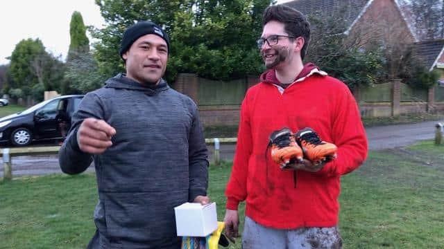 Tonga's Rugby World Cup star Sonatane Takulua, left, presents his boots to Sunderland dad Michael McRae.