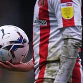 HIGH WYCOMBE, ENGLAND - JANUARY 08: A detailed view of the Puma EFL matchball as Alex Pritchard of Sunderland prepares to take a corner during the Sky Bet League One match between Wycombe Wanderers and Sunderland at Adams Park on January 08, 2022 in High Wycombe, England. (Photo by Alex Burstow/Getty Images)