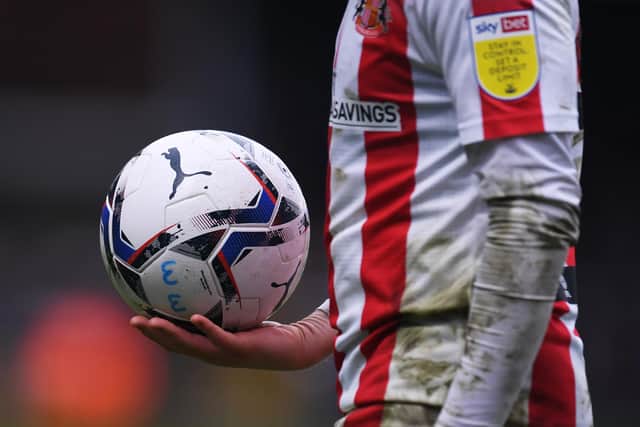 HIGH WYCOMBE, ENGLAND - JANUARY 08: A detailed view of the Puma EFL matchball as Alex Pritchard of Sunderland prepares to take a corner during the Sky Bet League One match between Wycombe Wanderers and Sunderland at Adams Park on January 08, 2022 in High Wycombe, England. (Photo by Alex Burstow/Getty Images)