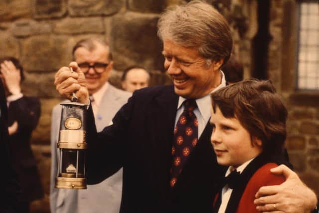 President Jimmy Carter with the miners lamp presented to him by Ian McAree, the youngest member of Washington Welfare Band in May 1977.