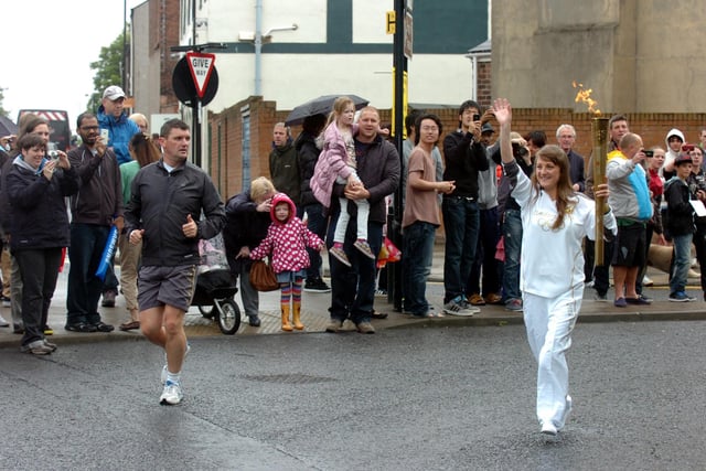 Rachel Haxon turns onto Chester Road with the torch in hand.