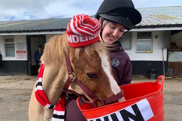 Yellow, pictured with yard staff member Georgia Shaw, has predicted a Sunderland victory in Sunday's Papa John's Trophy final.