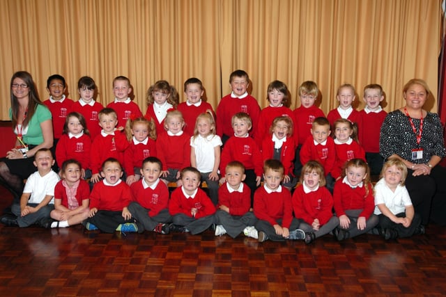 Teacher Louise Greenland and Nursery Nurse Lisa Walker with the smiling new starters at Plains Farm Primary. How many familiar faces can you spot?