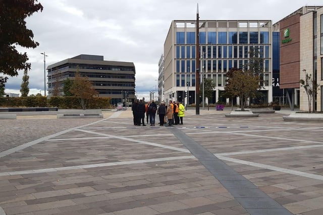 Officers and officials discuss the plan of action in Keel Square