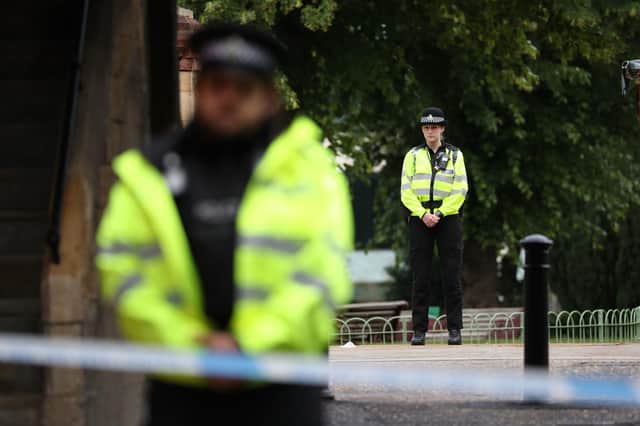 Police at the Abbey gateway of Forbury Gardens in Reading town centre following a multiple stabbing attack in the gardens which took place at around 7pm on Saturday leaving three people dead and another three seriously injured. PA Photo. Picture by Jonathan Brady/PA Wire