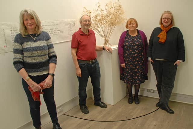 Artists Angela Sandwith, Barrie West, Francis Edward and Ellie Clewlow in front of artwork from Roland Buckingham-Hsiao.