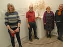 Artists Angela Sandwith, Barrie West, Francis Edward and Ellie Clewlow in front of artwork from Roland Buckingham-Hsiao.