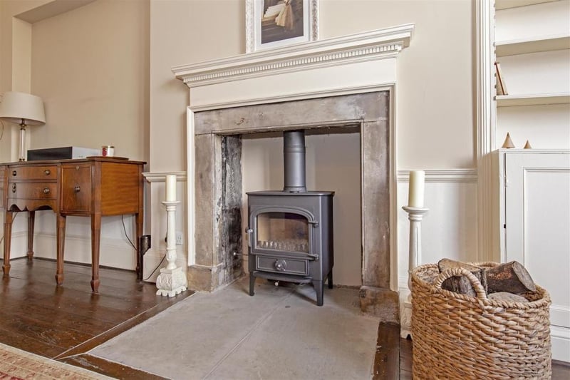 An exquisite feature fireplace with inset log burner.