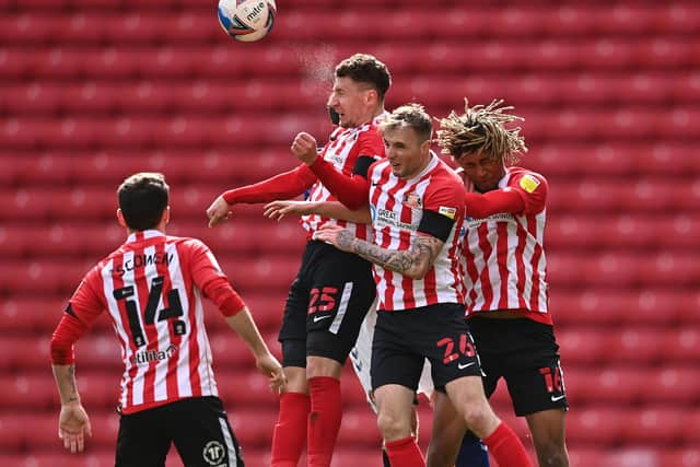 Sunderland players Callum McFadzean, Carl Winchester and Dion Sanderson go up to head the ball during the Sky Bet League One match between Sunderland and Charlton Athletic at Stadium of Light.