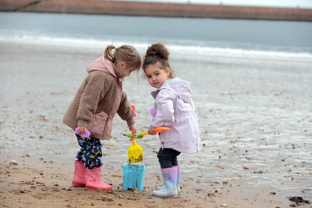 Alice Liddle, four and Gabriella Liddle, three, giving their full concentration to the sandcastle building!