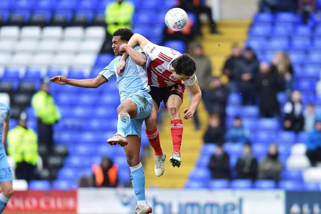 Luke O'Nien competes for the ball against Coventry City.