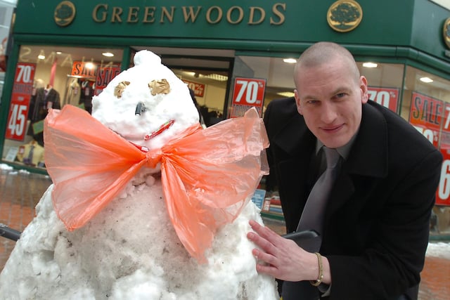 Mark Gelling from Greenwoods with a snowman he made outside the shop 13 years ago.