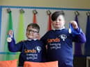 Brothers Billy, eight, and Henry Gibbon, seven, holding their medals after completing their charity run in memory their sister Gracie.