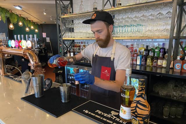 Bar manager Liam Duncan mixing a drink at 808 Bar & Kitchen. Picture by Frank Reid