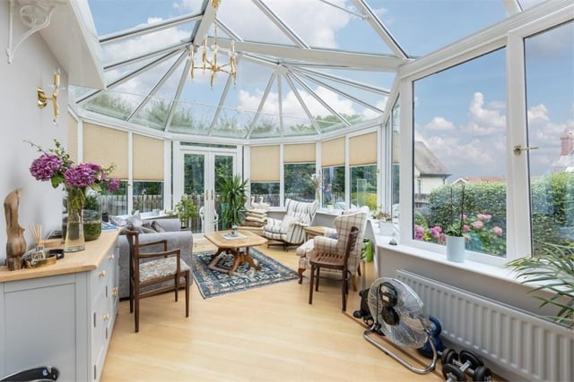 A large conservatory and bay windows take every opportunity maximise natural light.